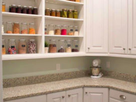 Pantry with white cabinetry and open shelving