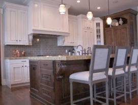 White cabinetry with natural wood island