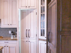 White cabinetry with hidden pantry door