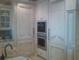 White kitchen cabinetry with beautiful carvings