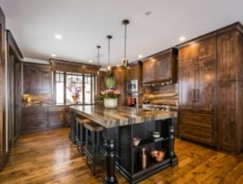Wood kitchen cabinetry with black island