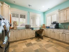 Large Laundry/Craft Room. White cabinetry with dark glaze and bright aqua walls.