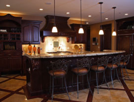 Dark alder wood kitchen with beautiful carvings on corbels and hood.