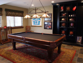 Game room with floor to ceiling book shelfs