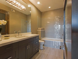 Bathroom with dark cabinetry and white countertops