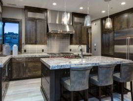 Gray quarter sawn oak kitchen cabinetry with granite counter tops