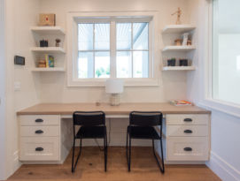 Homework room for the kids with white cabinetry and floating corner shelves