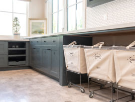 laundry room with lots of storage space and vintage industrial rolling laundry baskets