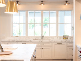 White kitchen with lots of natural light coming in those big windows