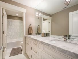 Spacious bathroom. White cabinetry with gray counter tops.