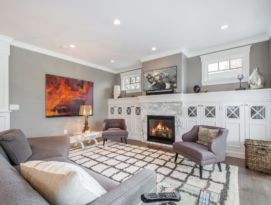 Gray and white living room with built-ins around the fireplace