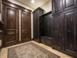 Mud room with distressed black lockers and bench seating with drawers below