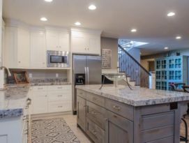 White kitchen cabinetry with gray island and gray granite counter tops