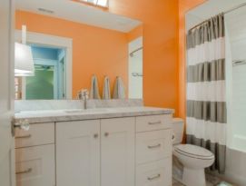 Fun kids bath with bright walls and white vanity