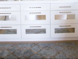 Butler pantry with white cabinetry and counter tops and mirrored drawers