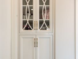 white linen closet with glass doors