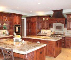 Alder cabinetry with detailed carvings and two islands