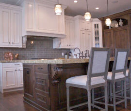 White cabinetry with natural wood island