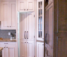 White cabinetry with hidden pantry door