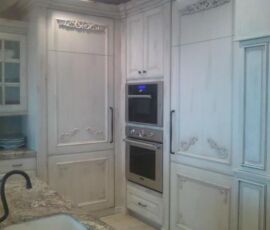 White kitchen cabinetry with beautiful carvings