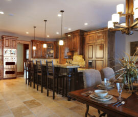 Spacious kitchen with natural wood cabinetry and dark island
