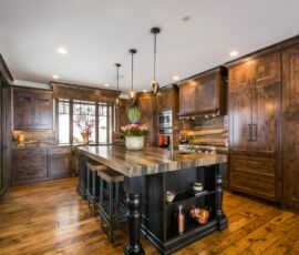 Wood kitchen cabinetry with black island