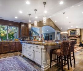 Natural wood kitchen cabinetry with white island