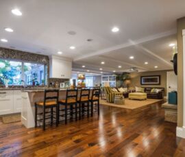 White kitchenette with tiled back splash and hardwood floors