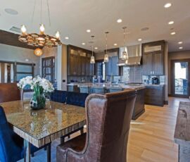 Gray kitchen cabinetry with contemporary dining area