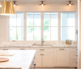 White kitchen with lots of natural light coming in those big windows