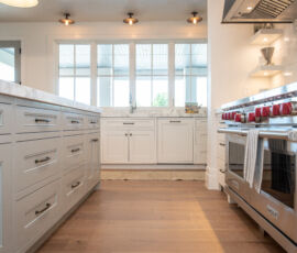 White and gray kitchen with natural woods