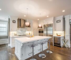 White kitchen cabinetry and counter tops with hardwood floor