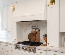 white kitchen with custom hood